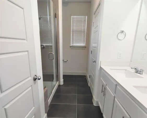 a bathroom with a sink a mirror and a shower