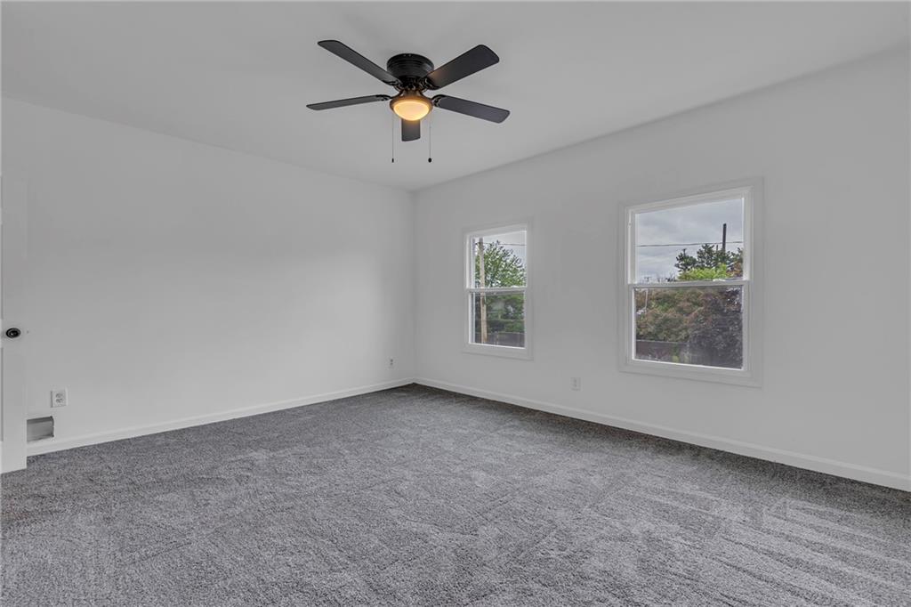 193 Virginia Avenue Rochester, PA 15074 - Photo 17 of 37 an empty room with a window and a ceiling fan