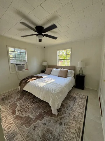 a bedroom with a bed and a window