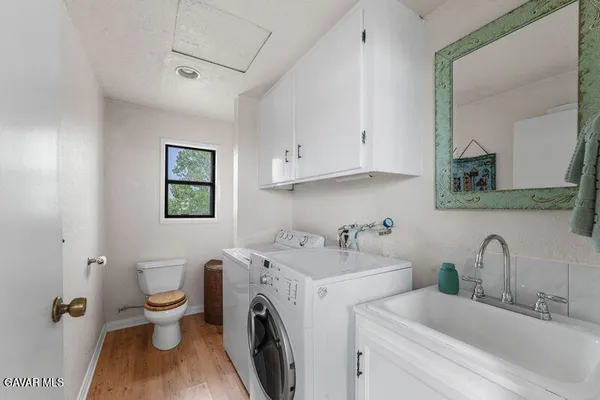 a view of a kitchen with sink washer and dryer