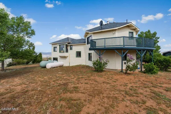 a view of balcony with wooden floor and fence