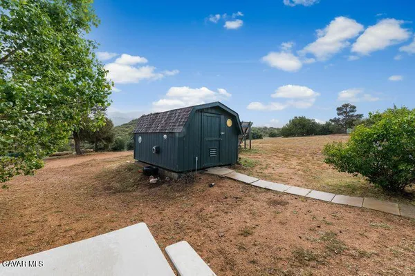 a view of a house with a yard and sitting area