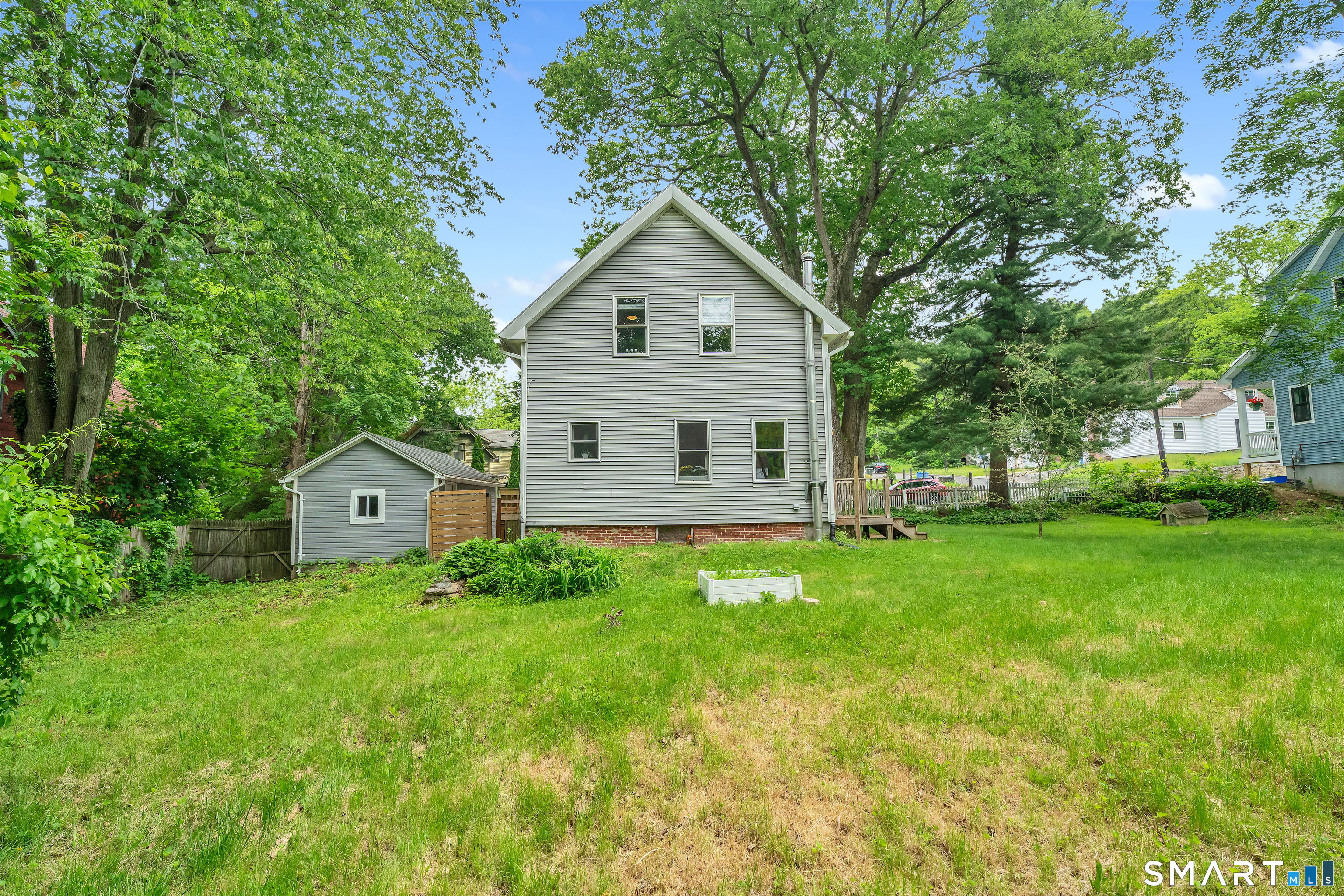 75 Summit Street Norwich, CT 06360 - Photo 40 of 40 a house view with a garden and large trees