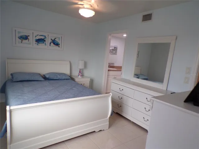a bedroom with a bed and cabinet