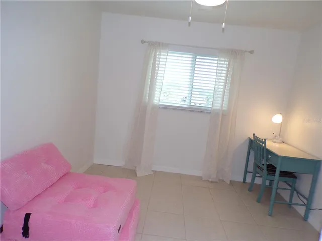 a bedroom with a bed a desk and chair