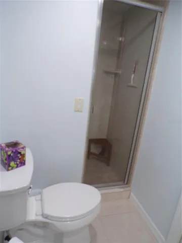 a white toilet sitting next to a sink