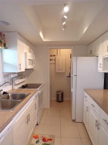a kitchen with a refrigerator sink and stove