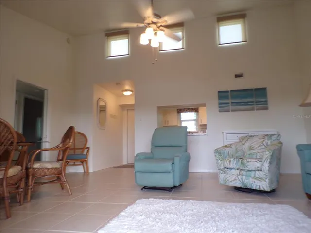 a living room with furniture a lamp and a window
