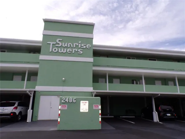 a front view of a building with parking area