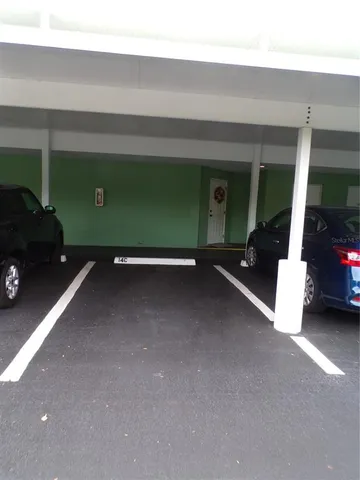 a living room with a large window and furniture