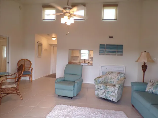 a living room with furniture a lamp and a chandelier