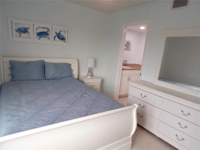 a bedroom with a bed and cabinet