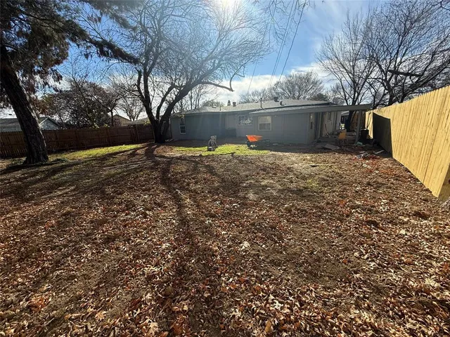 a view of a backyard with large trees