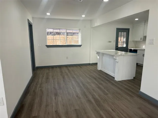 a view of kitchen with wooden floor and electronic appliances