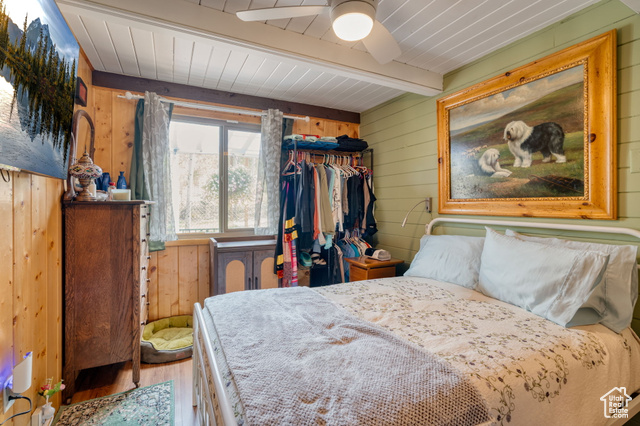 714 Spotted Fawn Way Kamas, UT 84036 - Photo 15 of 34 Bedroom with wooden walls, wood finished floors, ceiling fan, and a wood ceiling with exposed beams