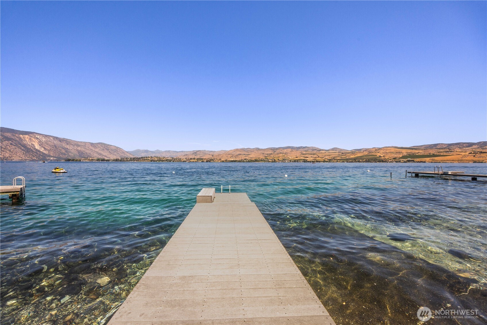 3132 South Lakeshore Road Chelan, WA 98816 - Photo 18 of 36 a view of a lake with a city