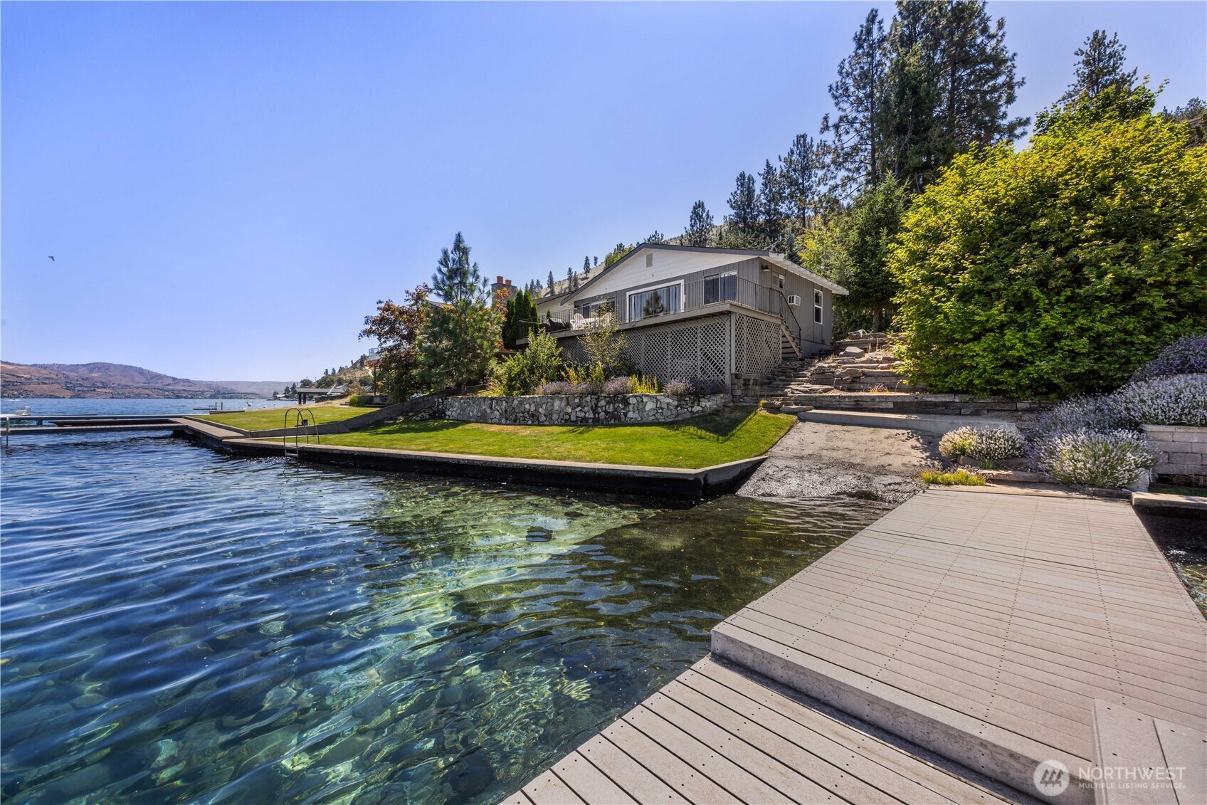 3132 South Lakeshore Road Chelan, WA 98816 - Photo 2 of 36 a view of a swimming pool with a lake view
