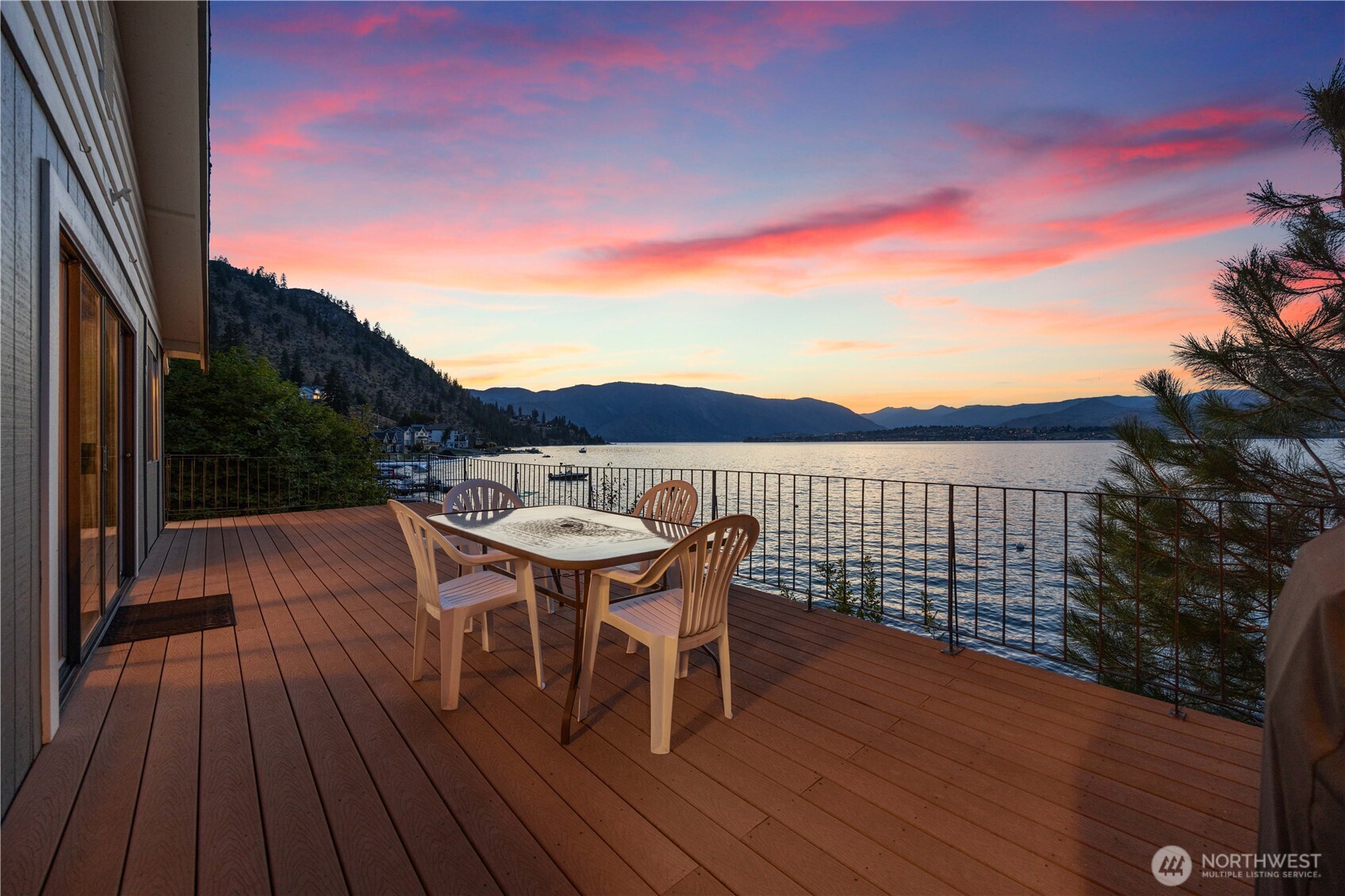3132 South Lakeshore Road Chelan, WA 98816 - Photo 24 of 36 a balcony with wooden floor table and chairs