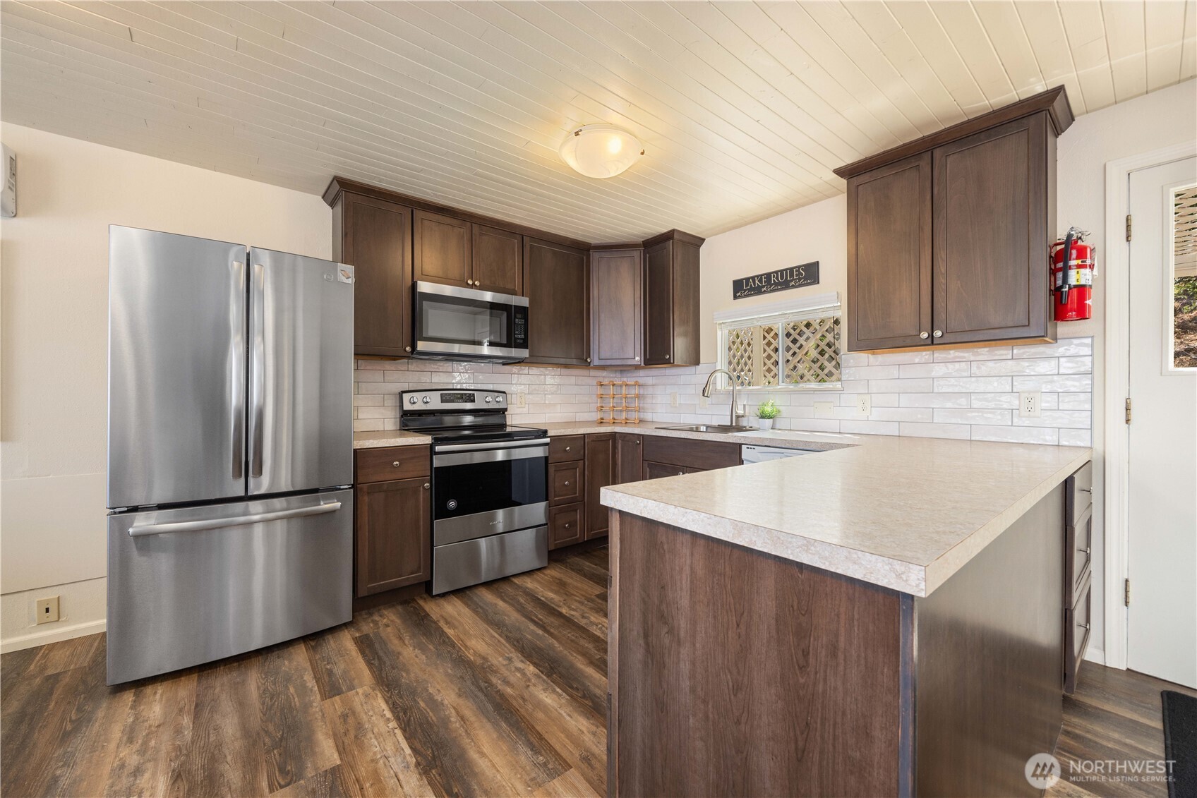 3132 South Lakeshore Road Chelan, WA 98816 - Photo 6 of 36 a kitchen with stainless steel appliances granite countertop a refrigerator sink and microwave