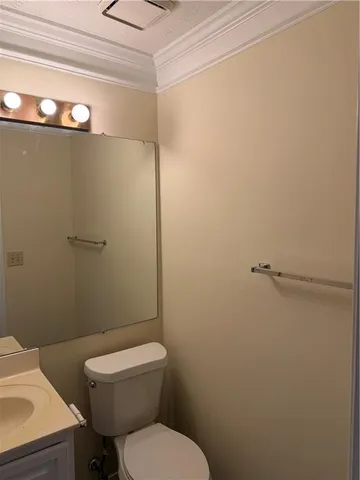 a white toilet sitting next to a shower in a bathroom