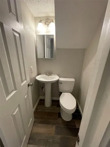 a white toilet sitting next to a bathroom sink