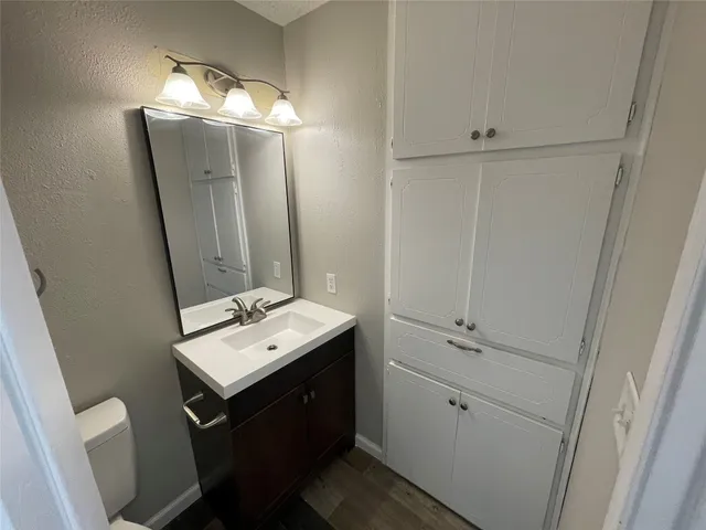 a bathroom with a toilet sink and shower