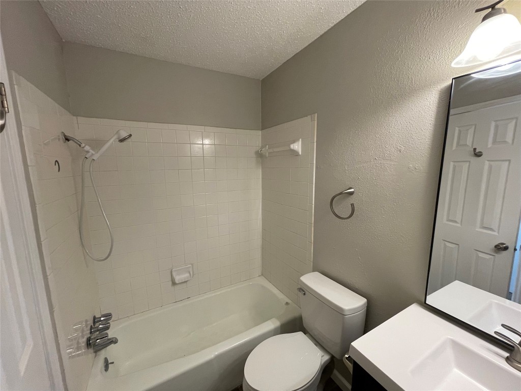 8810 Springmail Circle, Unit B Austin, TX 78729 - Photo 18 of 26 a bathroom with a toilet sink and shower