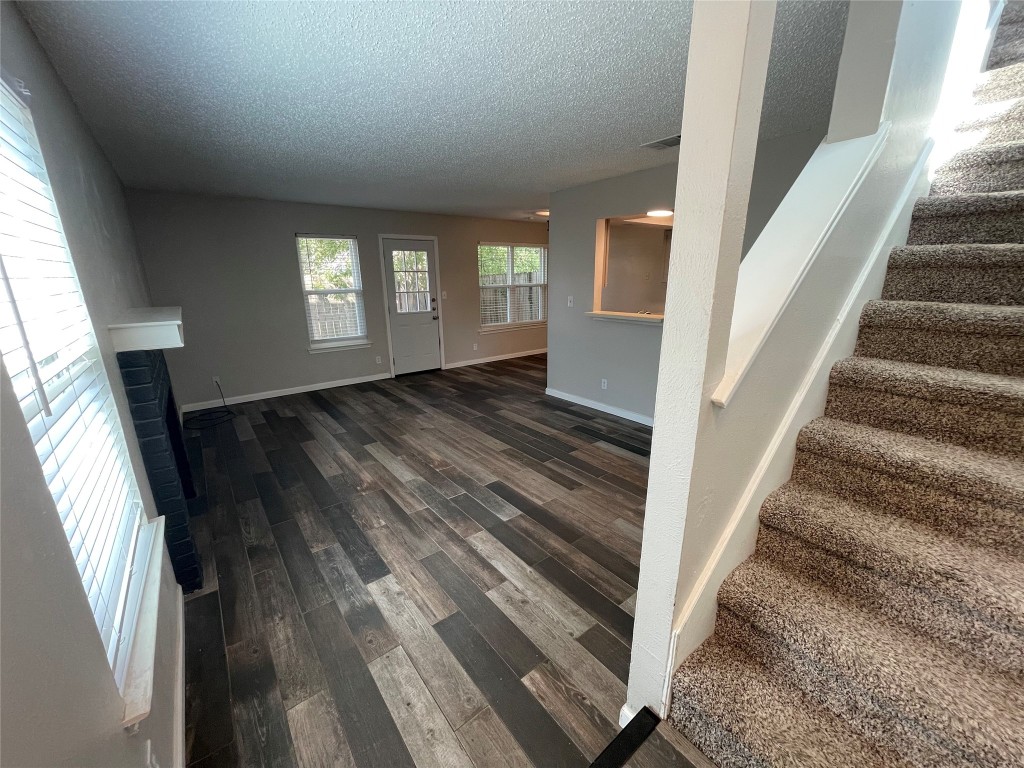 8810 Springmail Circle, Unit B Austin, TX 78729 - Photo 2 of 26 a view of an entryway with wooden floor and stairs