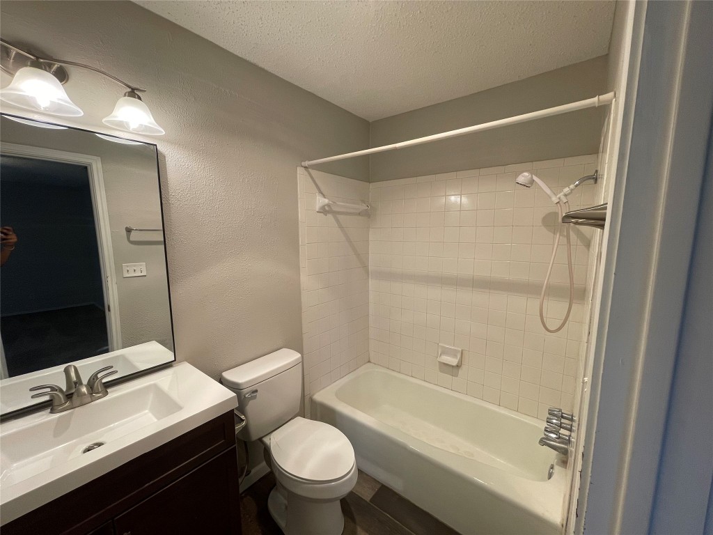 8810 Springmail Circle, Unit B Austin, TX 78729 - Photo 22 of 26 a bathroom with a sink mirror toilet and bathtub