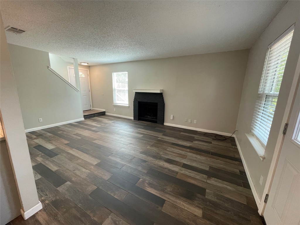 8810 Springmail Circle, Unit B Austin, TX 78729 - Photo 4 of 26 a view of empty room with wooden floor and fan