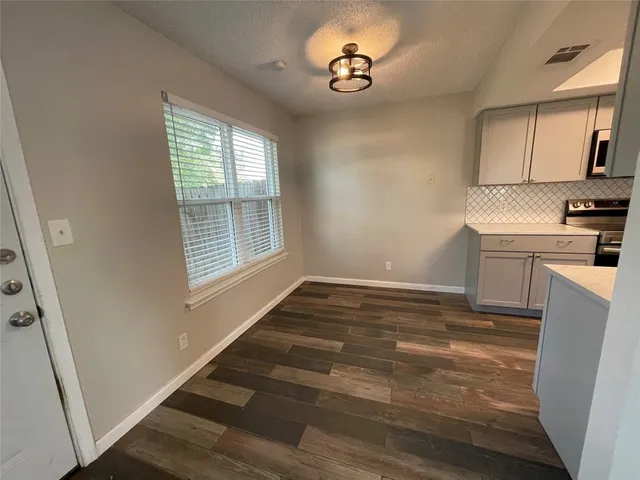 a view of a kitchen with a sink and dishwasher wooden floor