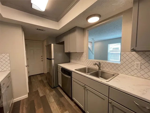 a kitchen with a sink and refrigerator