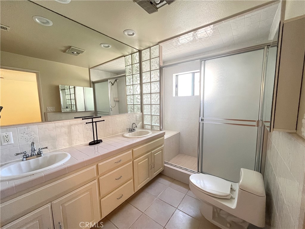 2103 Clark Lane, Unit A Redondo Beach, CA 90278 - Photo 14 of 14 a bathroom with a shower sink vanity mirror and toilet
