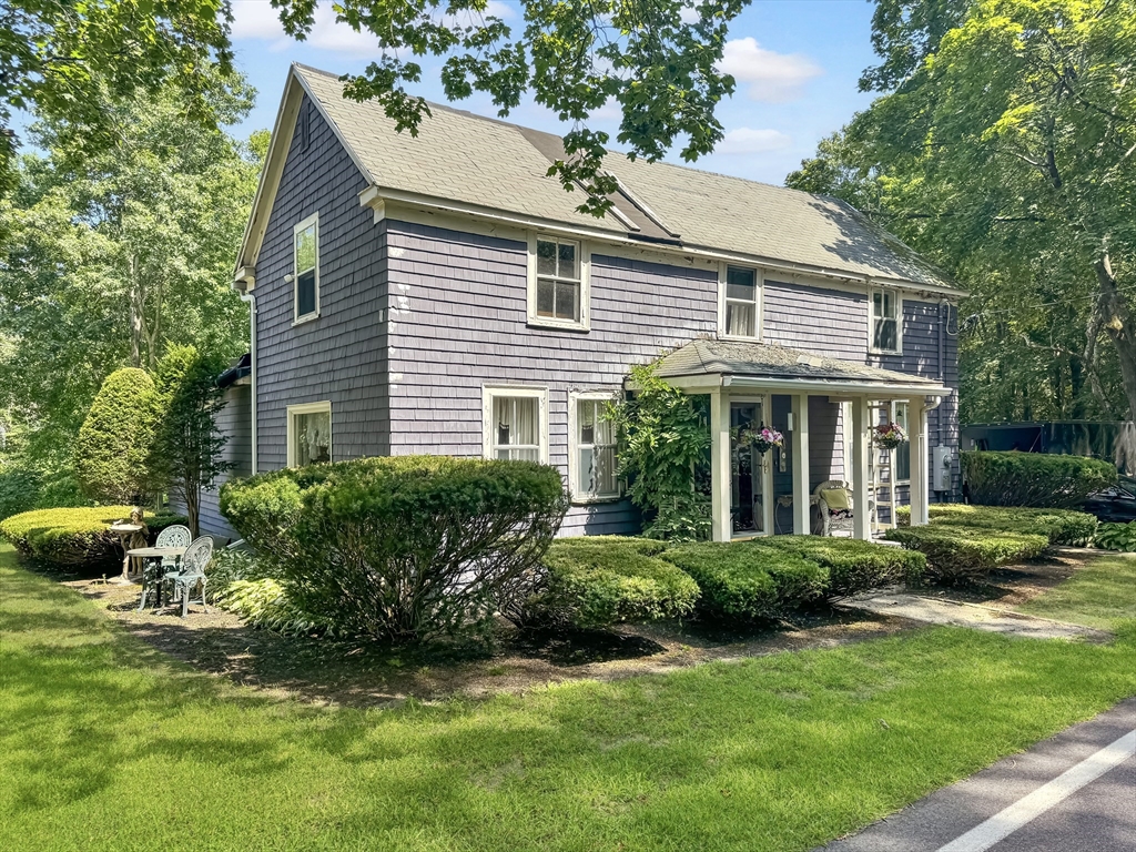 19 Haggetts Pond Road Andover, MA 01810 - Photo 1 of 24 a front view of a house with a yard and potted plants