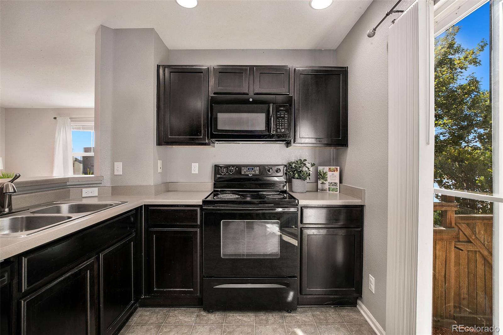 2011 Uinta Street Denver, CO 80238 - Photo 12 of 28 a kitchen with stainless steel appliances a sink stove and microwave