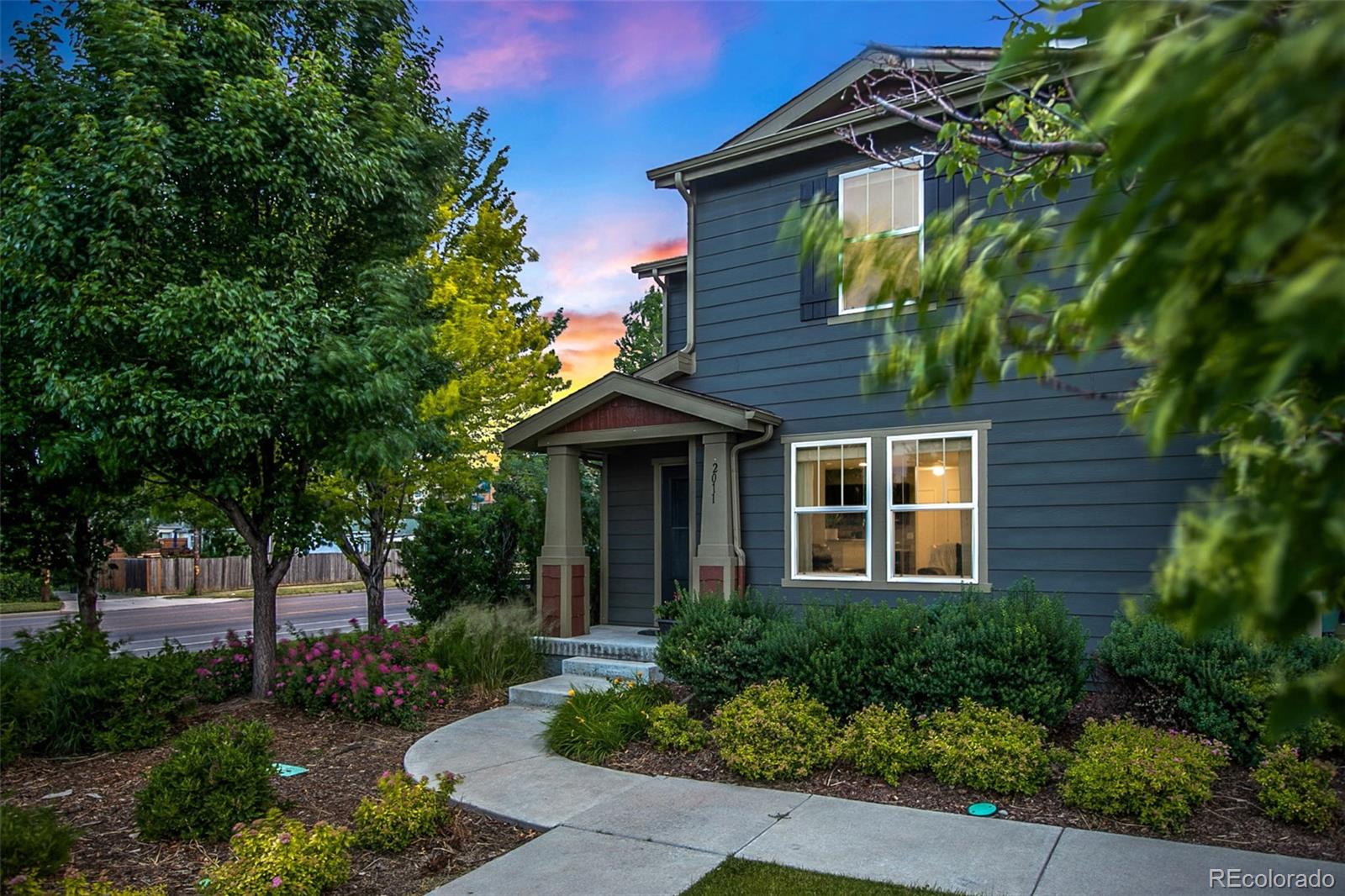 2011 Uinta Street Denver, CO 80238 - Photo 2 of 28 a front view of a house with a garden