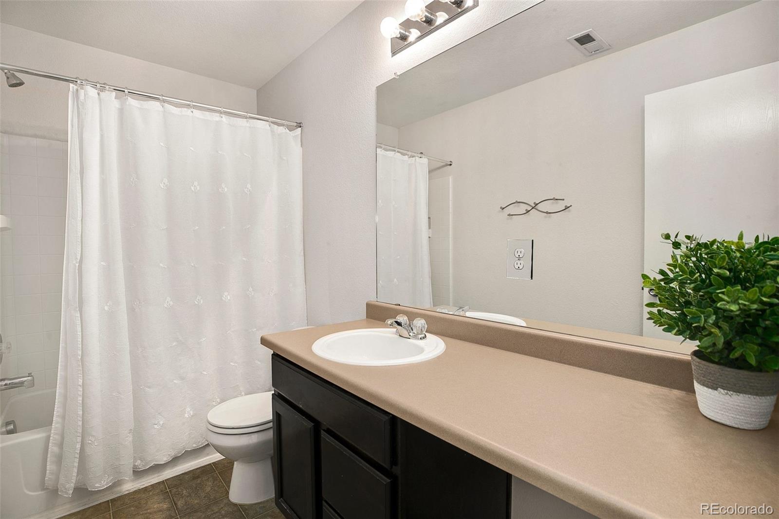2011 Uinta Street Denver, CO 80238 - Photo 23 of 28 a bathroom with a sink a toilet and shower