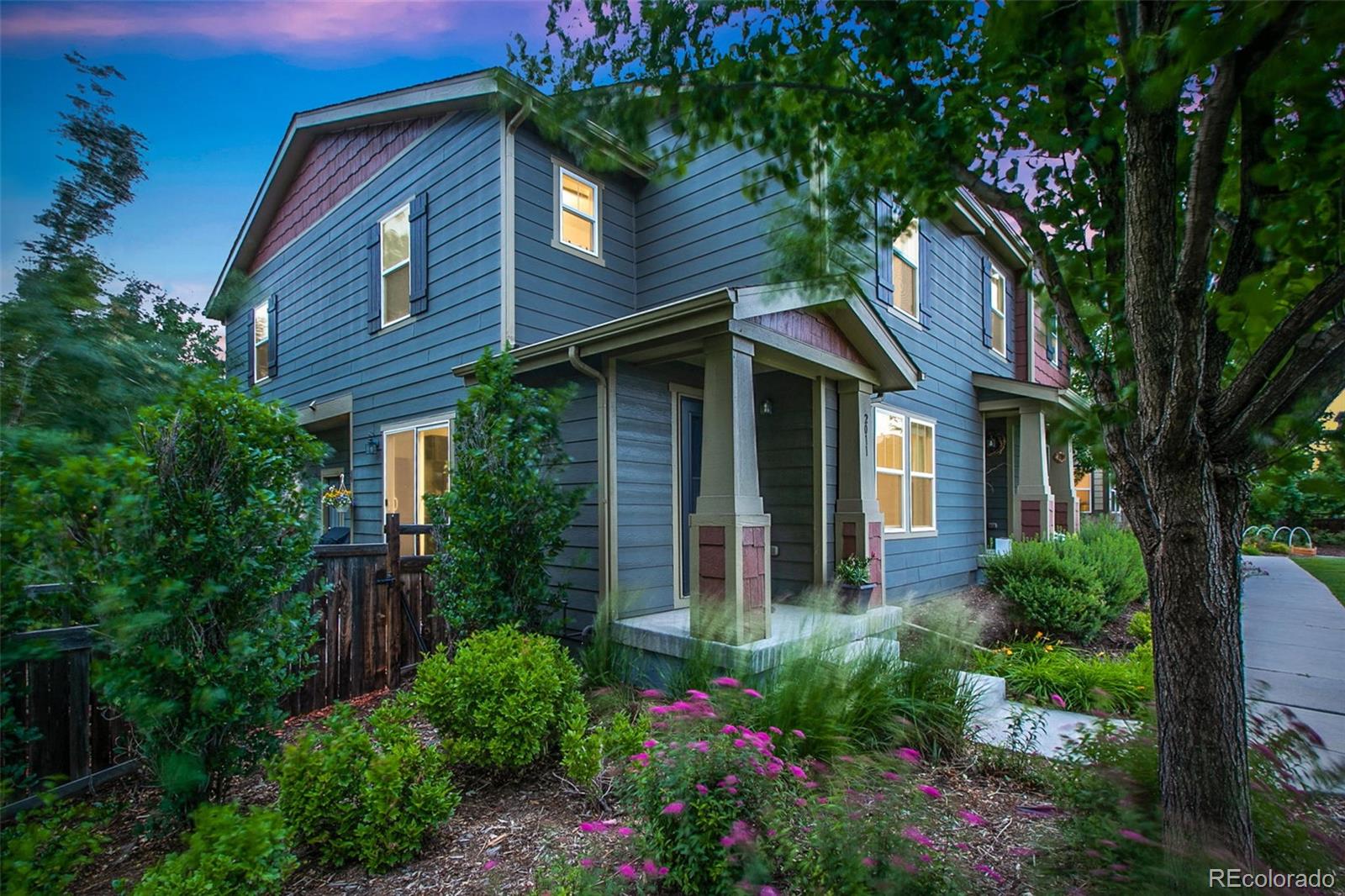 2011 Uinta Street Denver, CO 80238 - Photo 26 of 28 a view of a brick house with a flower garden