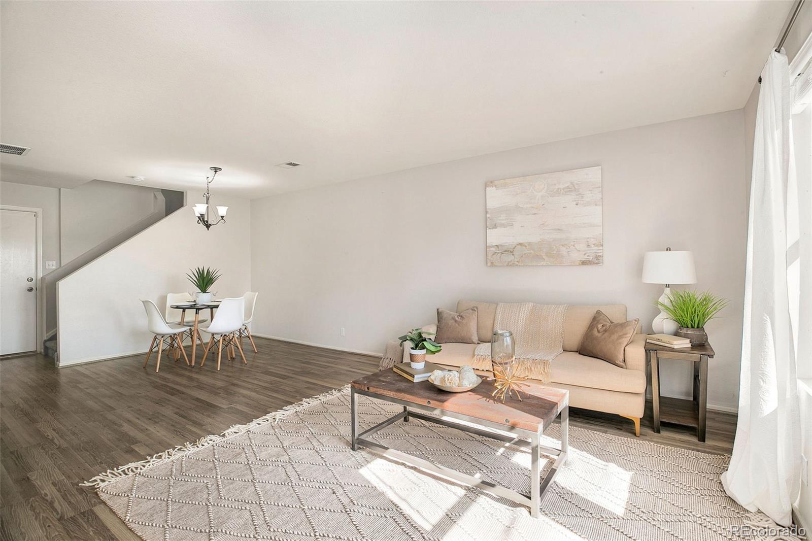 2011 Uinta Street Denver, CO 80238 - Photo 6 of 28 a living room with furniture and a dining table with wooden floor