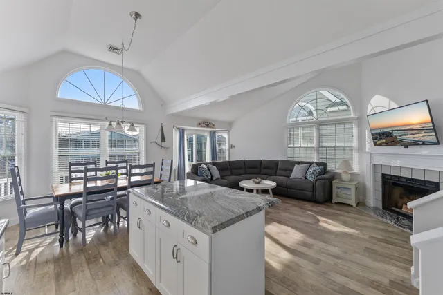 a living room with fireplace furniture and a chandelier