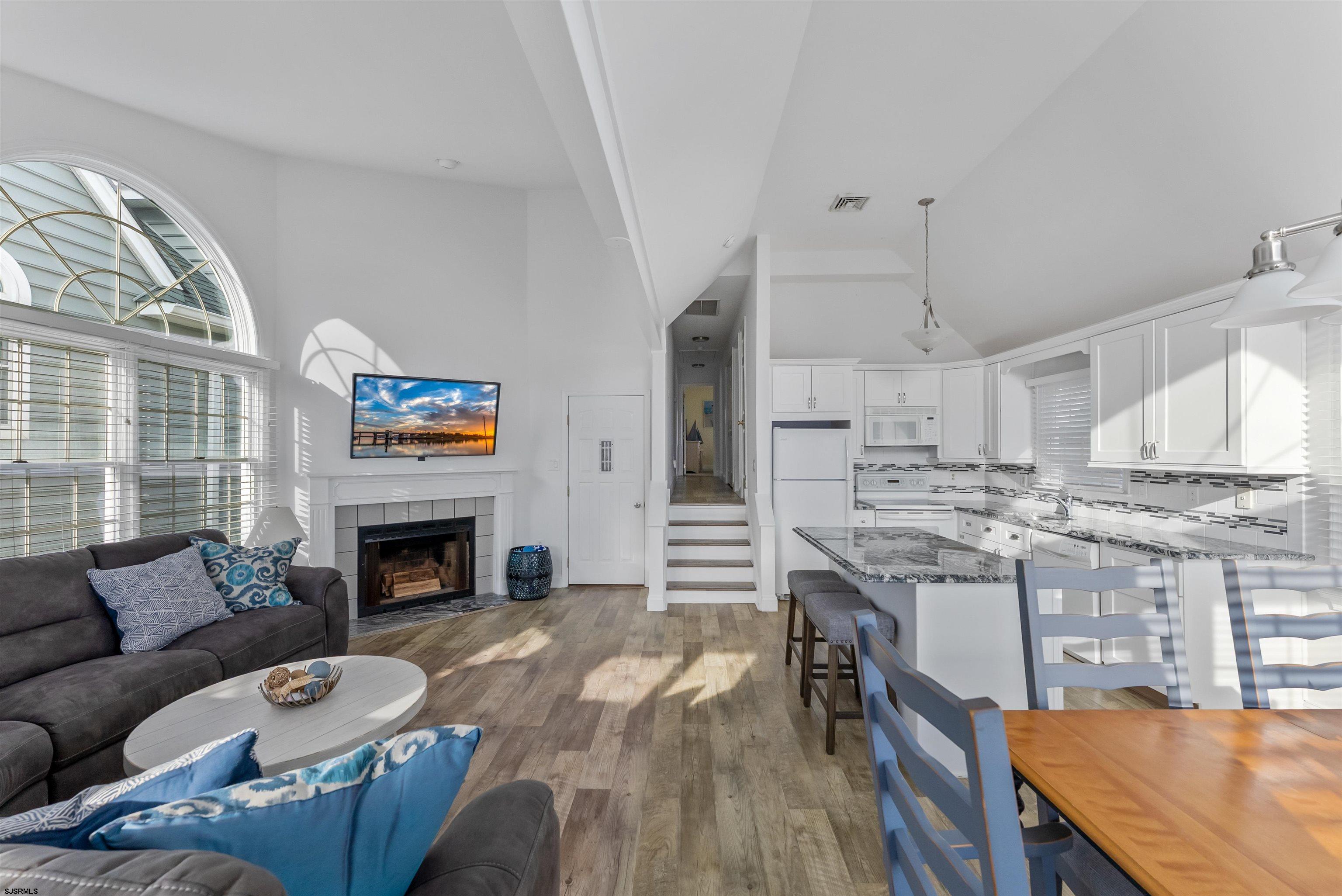 4930 Asbury Avenue, Unit 2 Ocean City, NJ 08226 - Photo 14 of 25 a living room with stainless steel appliances granite countertop furniture a fireplace a rug and a window