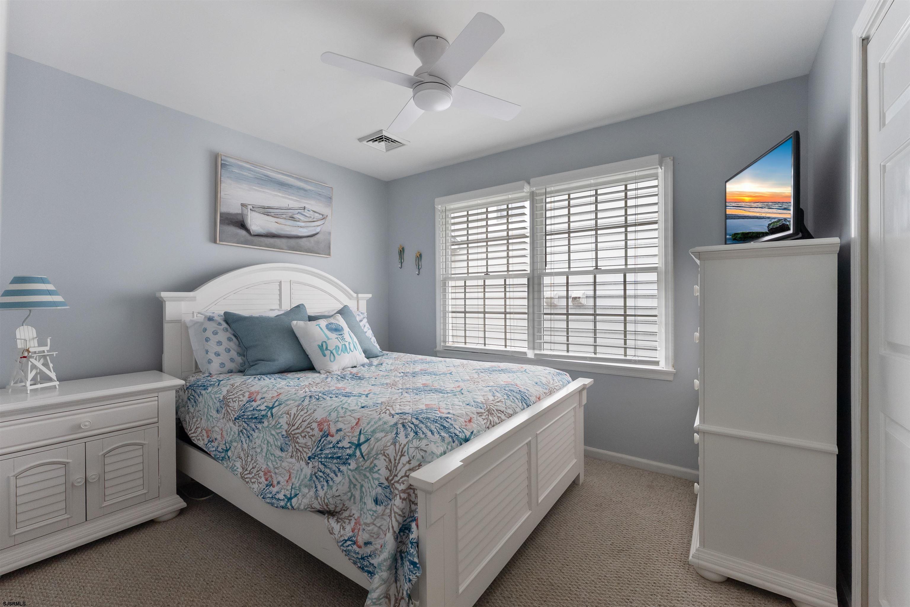 4930 Asbury Avenue, Unit 2 Ocean City, NJ 08226 - Photo 16 of 25 a bedroom with a bed and a window