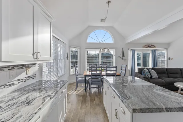 a living room with fireplace furniture and a large window