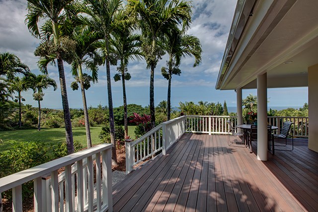 500 North Holokai Place Haiku, HI 96708 - Photo 14 of 17 a view of a deck with wooden floor and fence with a large garden