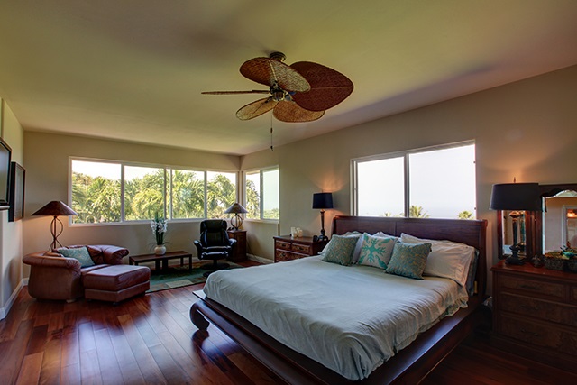 500 North Holokai Place Haiku, HI 96708 - Photo 6 of 17 a bedroom with a bed and wooden floor