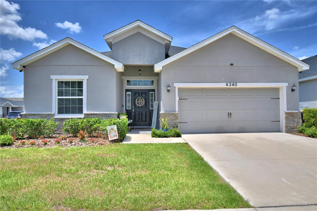 4340 Reding Way Lakeland, FL 33813 - Photo 2 of 63 a front view of a house with a yard and garage