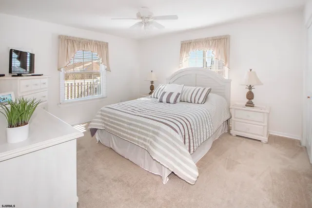 a bedroom with a white bed and a chandelier