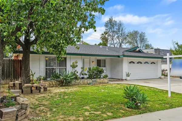 a front view of house with yard and outdoor seating