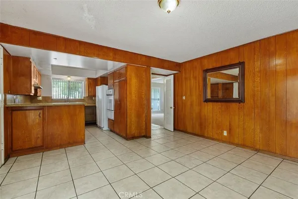 an empty room with a kitchen view