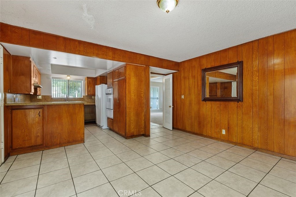 786 Spruce Street Riverside, CA 92507 - Photo 13 of 29 an empty room with a kitchen view